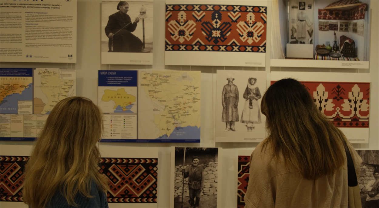Наталія, Анастасія та Олександра на виставці «КРИМ: ВЧОРА, СЬОГОДНІ, ЗАВТРА», біля експозиції надазовських греків «ТОХМА» 